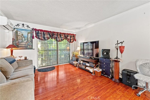 living room with a wall mounted air conditioner, wood-type flooring, and crown molding