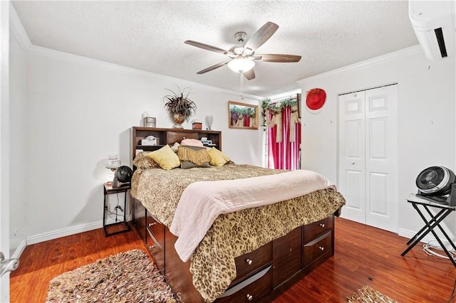 bedroom featuring ceiling fan, a closet, dark wood-type flooring, and a textured ceiling