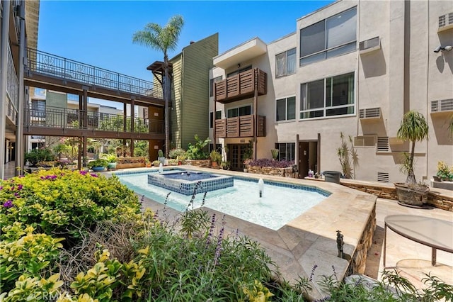 view of swimming pool featuring an in ground hot tub