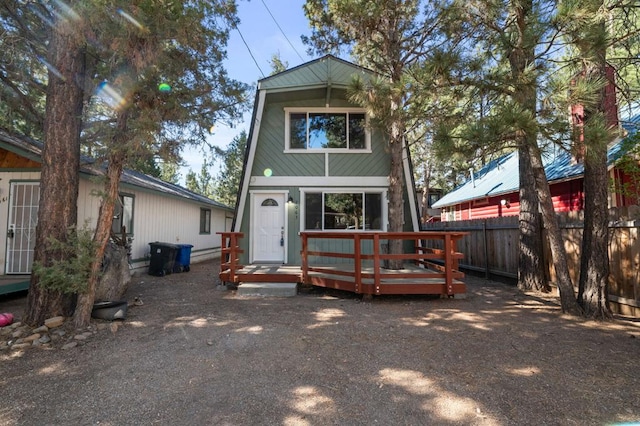 rear view of property with a wooden deck