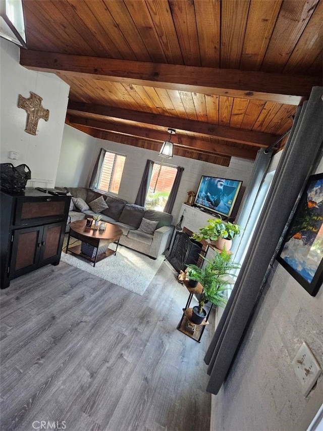 living room with light hardwood / wood-style flooring, beamed ceiling, and wood ceiling