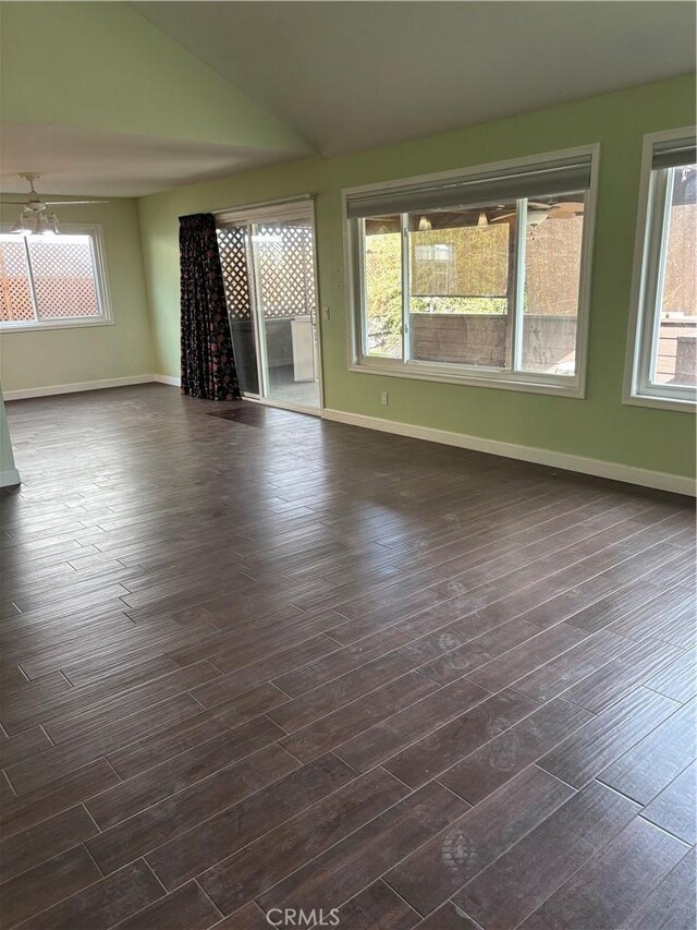 interior space featuring vaulted ceiling and dark hardwood / wood-style flooring