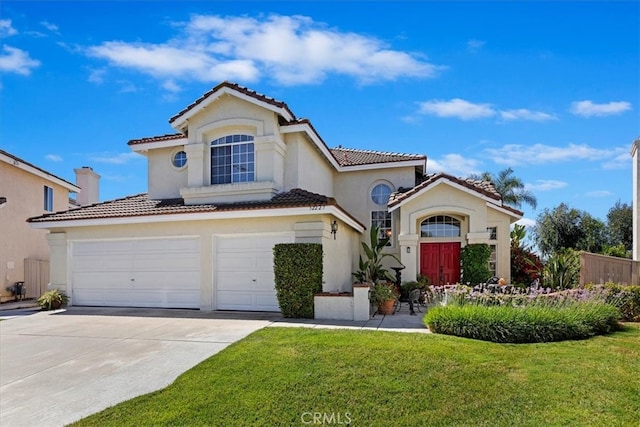 mediterranean / spanish-style house with a front lawn and a garage