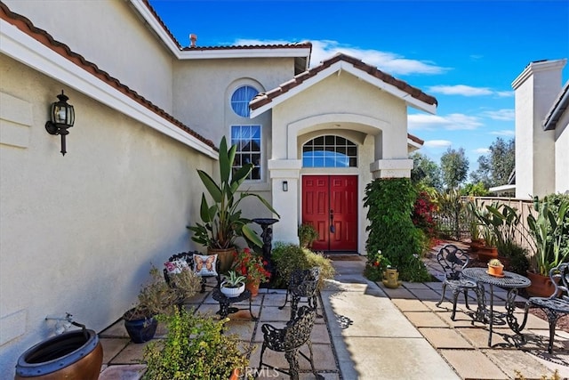 view of exterior entry featuring a patio