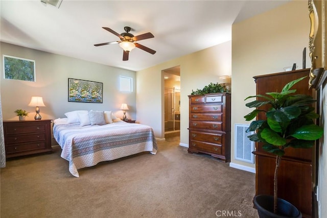 bedroom with carpet flooring, ceiling fan, and ensuite bath