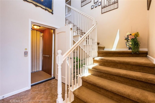 stairway with tile patterned floors