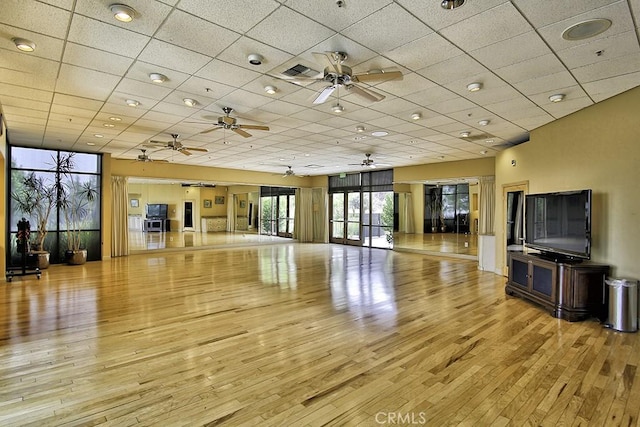 interior space featuring a drop ceiling and light wood-type flooring