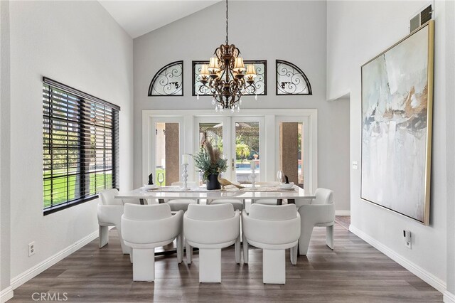 dining space with high vaulted ceiling, a chandelier, and dark wood-type flooring