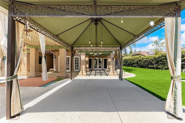 view of patio featuring ceiling fan, a gazebo, and french doors