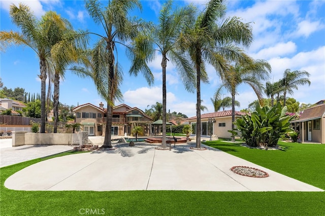 view of front of property with a patio and a front lawn