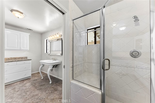 bathroom featuring tile patterned flooring and an enclosed shower