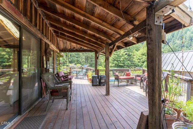 wooden terrace with an outdoor hangout area