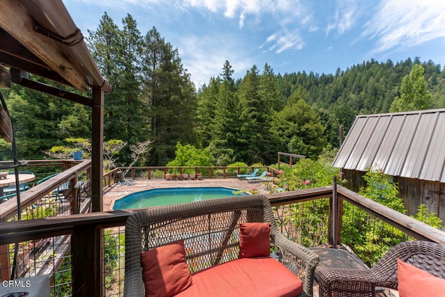 wooden terrace featuring a fenced in pool