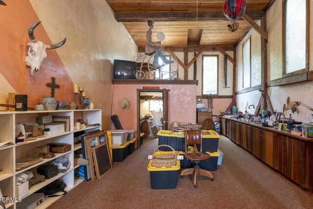 interior space featuring vaulted ceiling with beams, carpet, and wooden ceiling