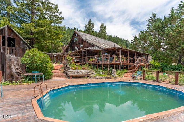 view of swimming pool featuring a wooden deck