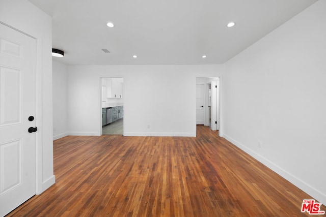 spare room featuring dark wood-type flooring