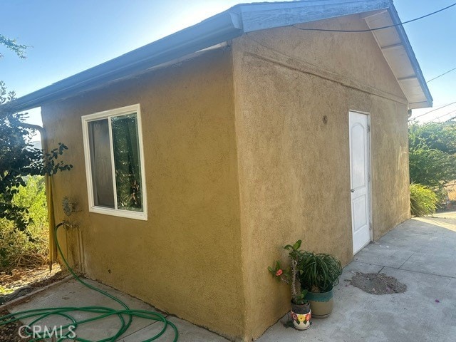 view of side of home featuring stucco siding