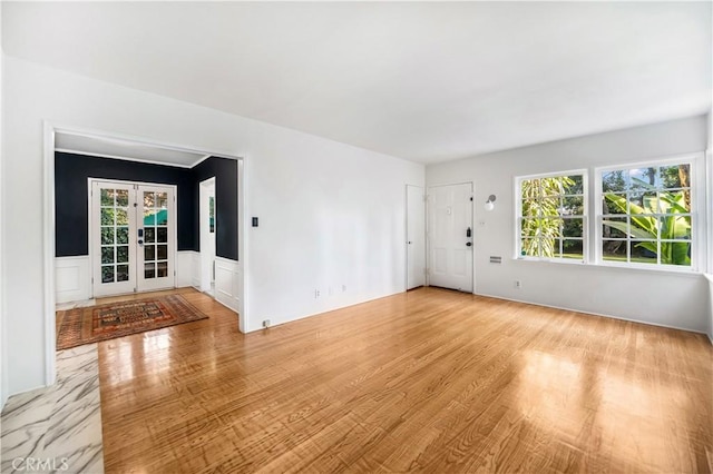 interior space with french doors and light wood-type flooring