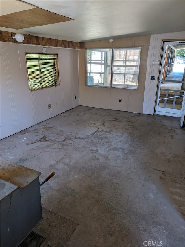 interior space featuring concrete flooring and vaulted ceiling