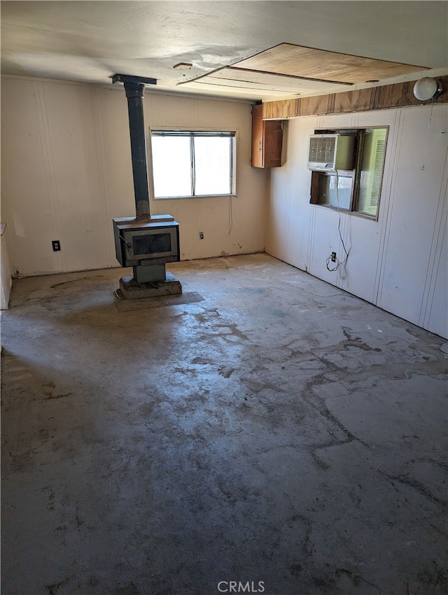 unfurnished living room with a wood stove