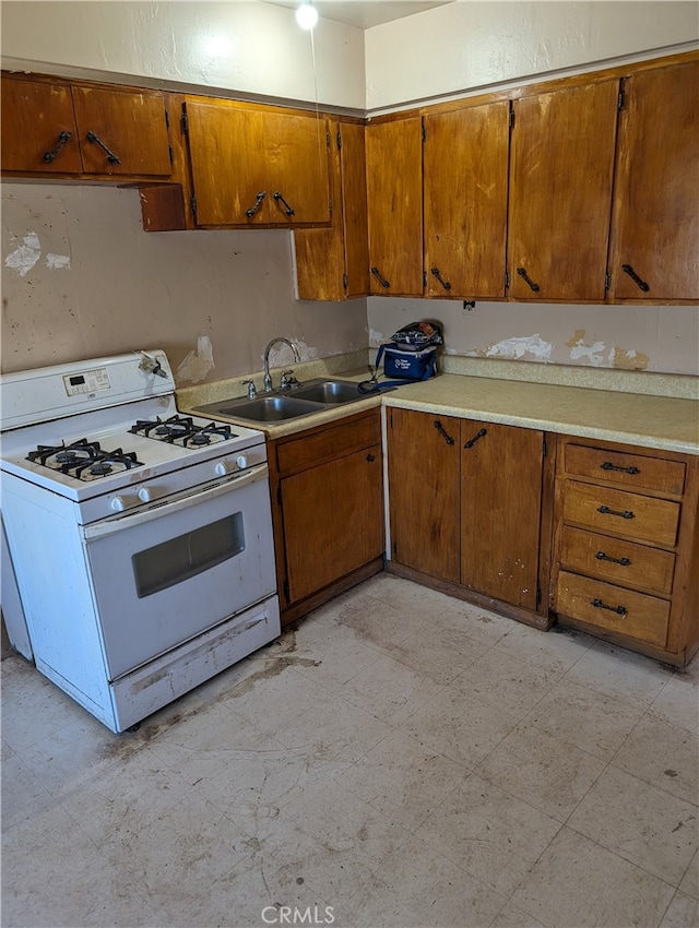 kitchen featuring gas range gas stove and sink