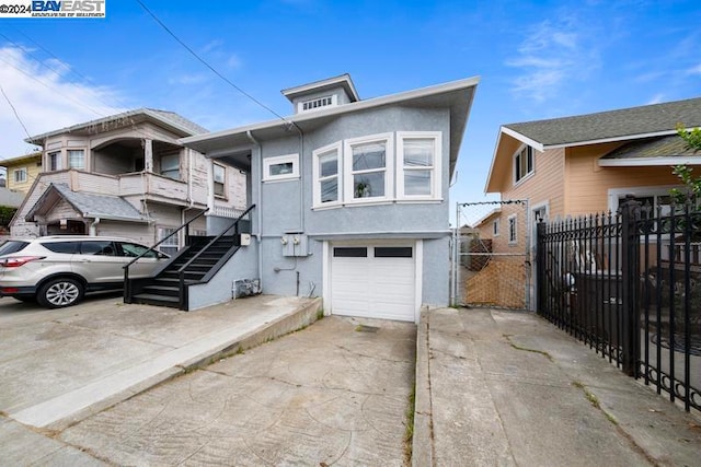 view of front of property featuring a balcony and a garage