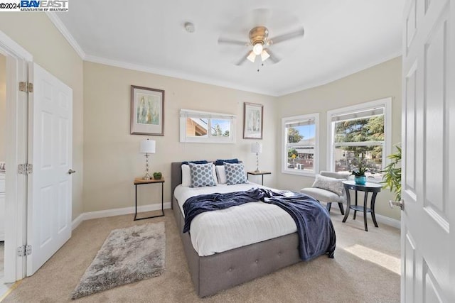 bedroom featuring ornamental molding, light carpet, and ceiling fan