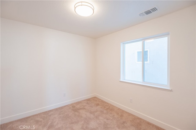 empty room featuring light carpet