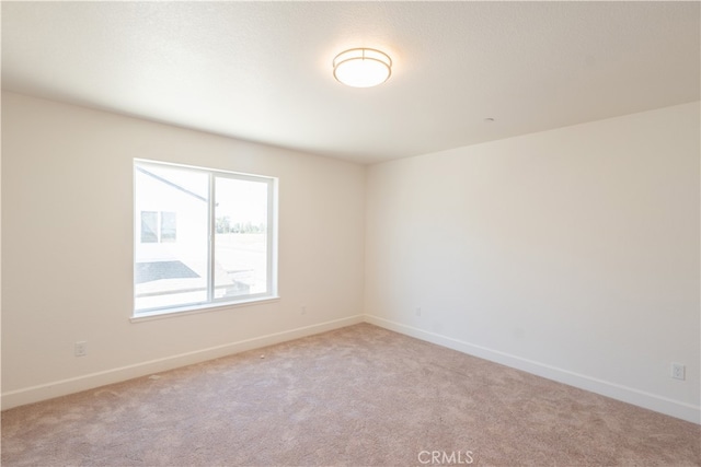 unfurnished room with light carpet