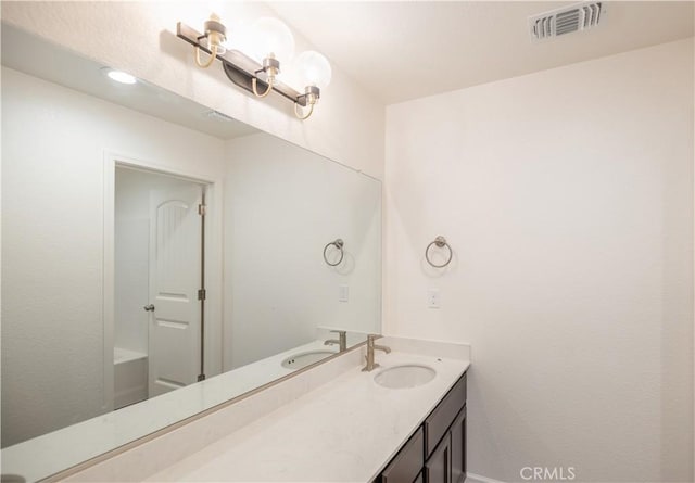 bathroom featuring vanity and visible vents