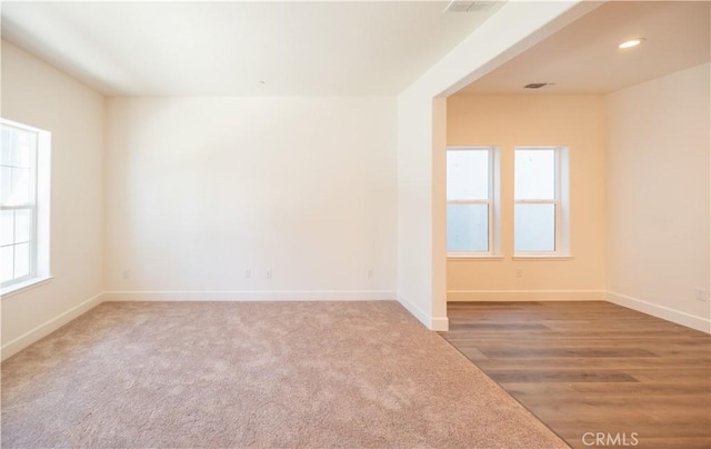 carpeted spare room with recessed lighting, visible vents, and baseboards