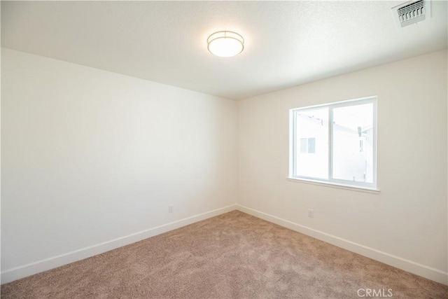 unfurnished room featuring light carpet, baseboards, and visible vents
