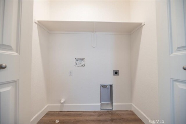 washroom featuring laundry area, electric dryer hookup, wood finished floors, gas dryer hookup, and baseboards