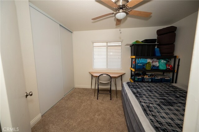 carpeted bedroom with ceiling fan and a closet