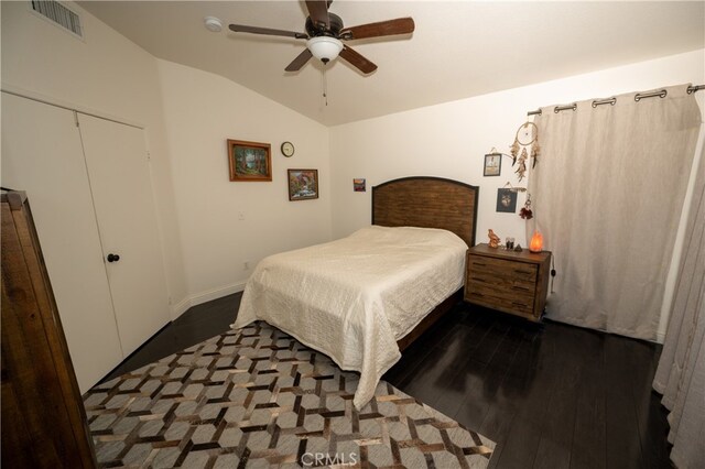 bedroom with a closet, vaulted ceiling, ceiling fan, and dark hardwood / wood-style flooring