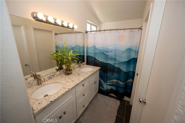 bathroom featuring vaulted ceiling, walk in shower, and vanity