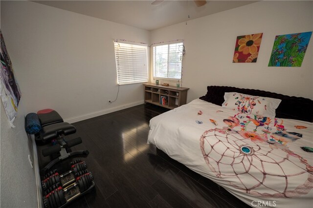 bedroom with ceiling fan and dark wood-type flooring