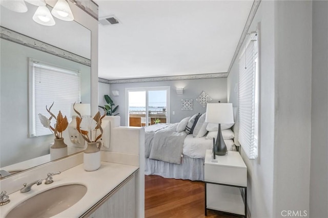 bedroom featuring sink and dark hardwood / wood-style floors