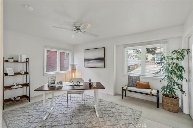 home office featuring ceiling fan and light colored carpet