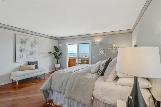 bedroom featuring hardwood / wood-style flooring and access to outside