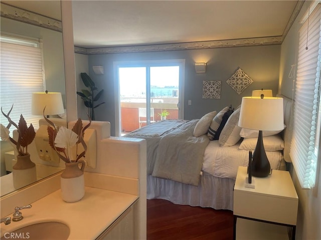 bedroom featuring crown molding, sink, access to outside, and dark hardwood / wood-style flooring