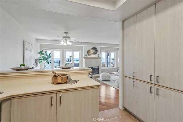 kitchen with ceiling fan, light brown cabinetry, and light tile patterned floors