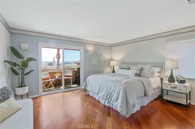 bedroom featuring hardwood / wood-style flooring and access to exterior