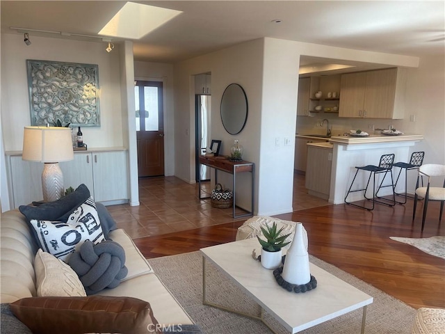 living room with sink and hardwood / wood-style floors