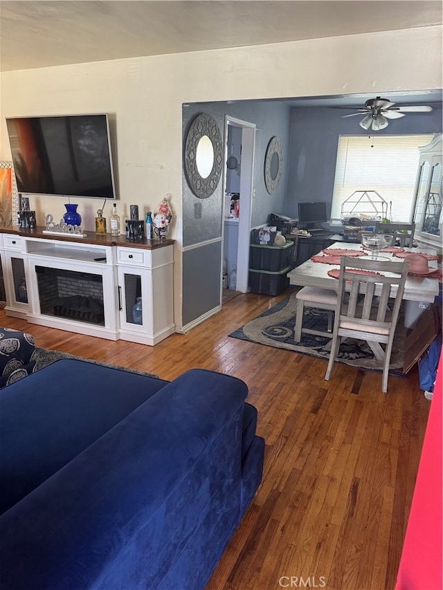 living room featuring hardwood / wood-style flooring and ceiling fan