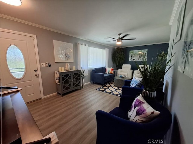 living room with crown molding, ceiling fan, and wood-type flooring