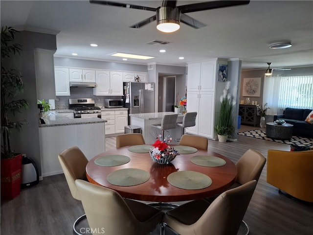 dining room featuring ceiling fan, dark hardwood / wood-style flooring, and ornamental molding