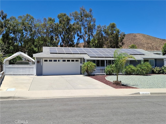 ranch-style house with a mountain view and a garage