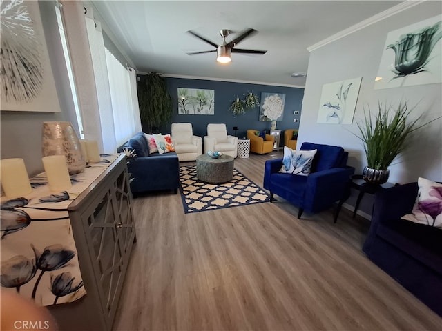 living room with ceiling fan, wood-type flooring, and ornamental molding