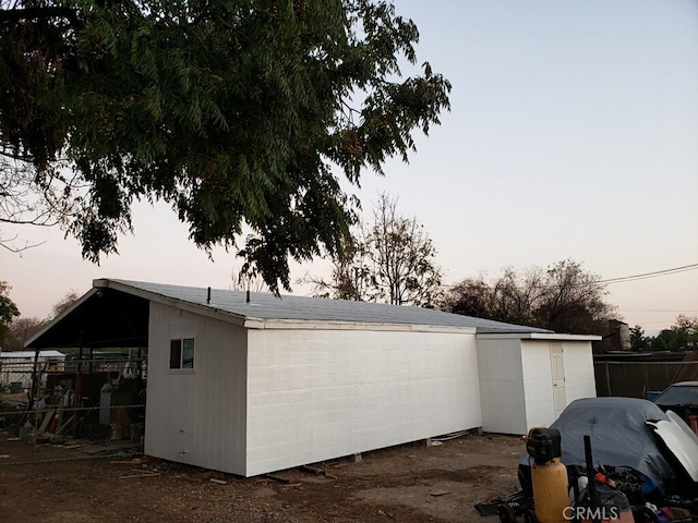 view of garage at dusk